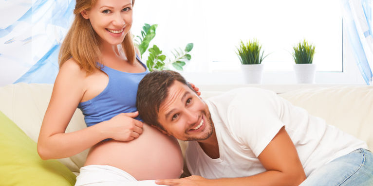 happy family in anticipation of the birth of baby. Pregnant woman and her husband at home
