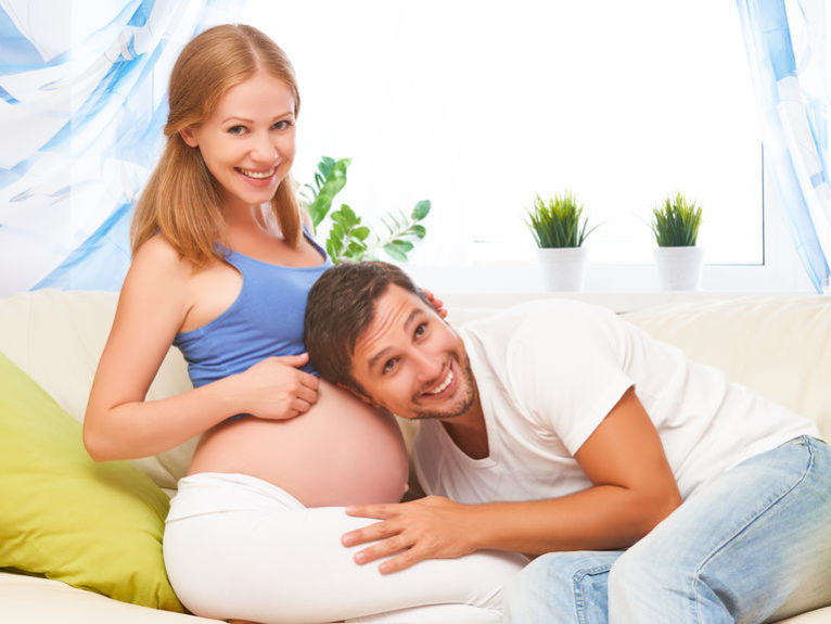 happy family in anticipation of the birth of baby. Pregnant woman and her husband at home